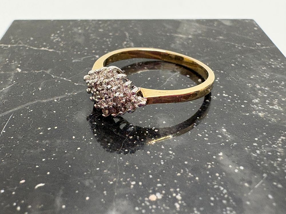 Lot 39: A 9ct yellow gold pink gemstone cluster ring presented in a Goldsmiths box