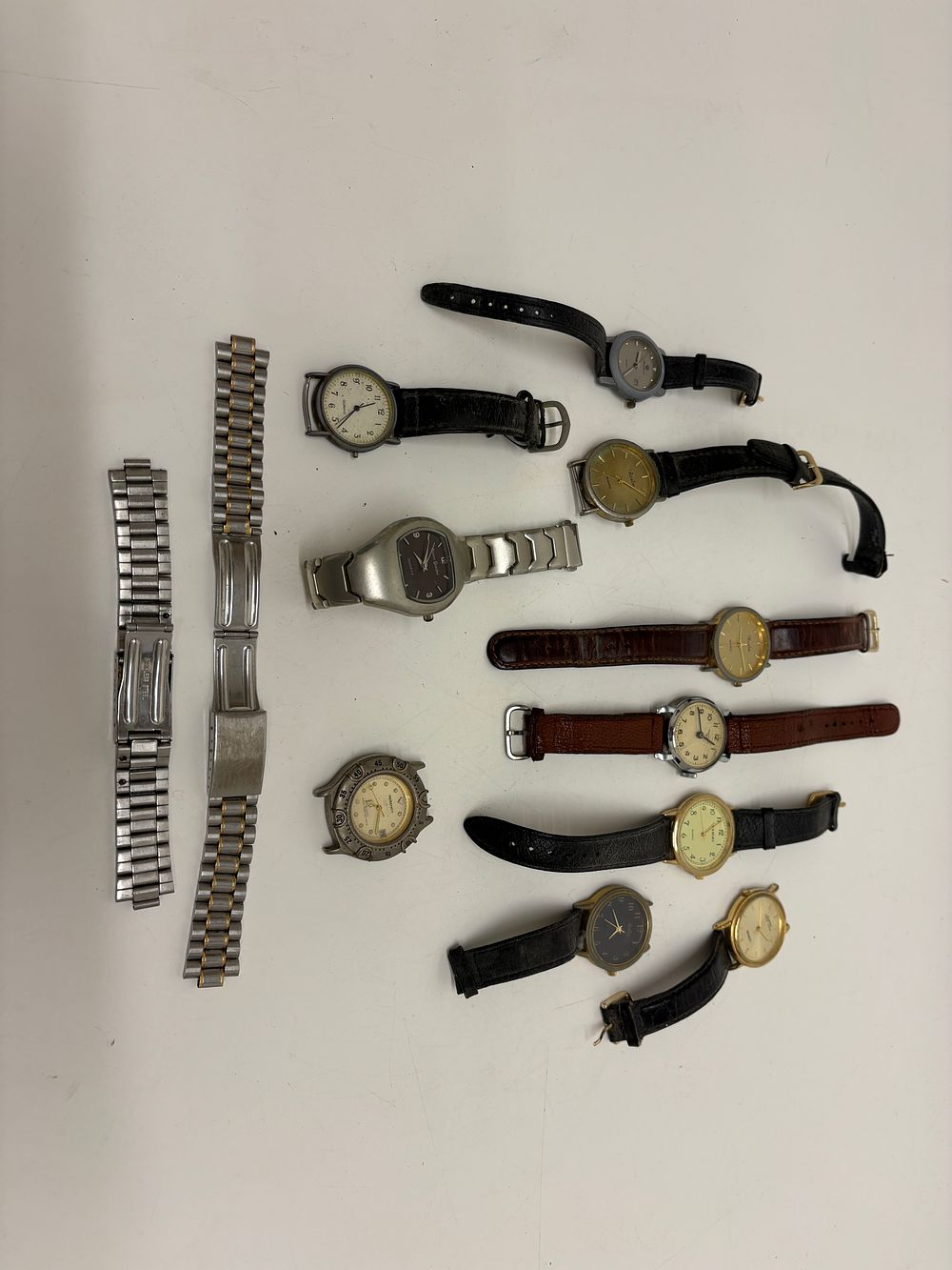 Lot 675: An Assortment of Quartz and Mechanical Wristwatches including Lorus, Realm, and Pierre Gordni