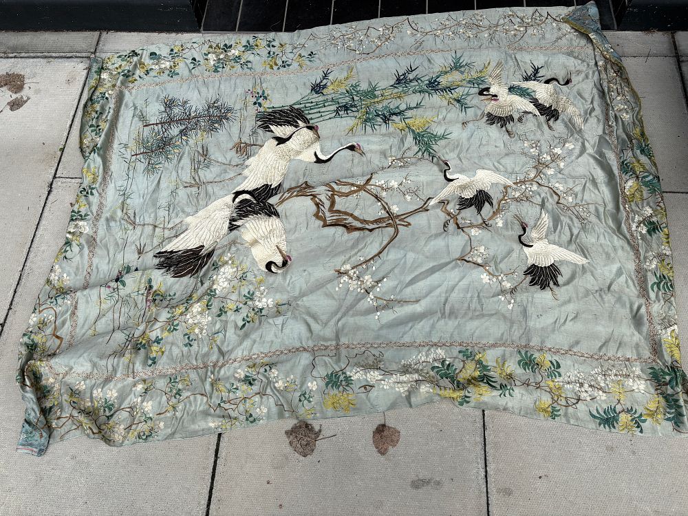 Lot 666: A large Chinese hand-embroidered silk panel decorated with cranes amidst pine, bamboo, and prunus