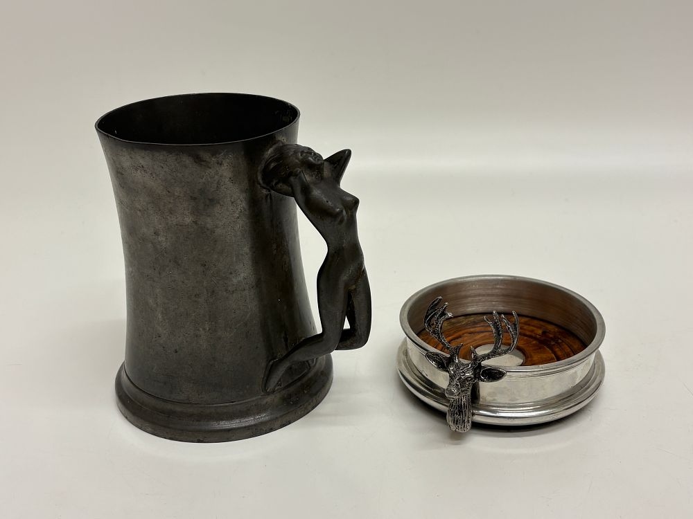 Lot 647: Two pewter decorative items comprising a Manor Pewter figural tankard and a stag head bottle coaster
