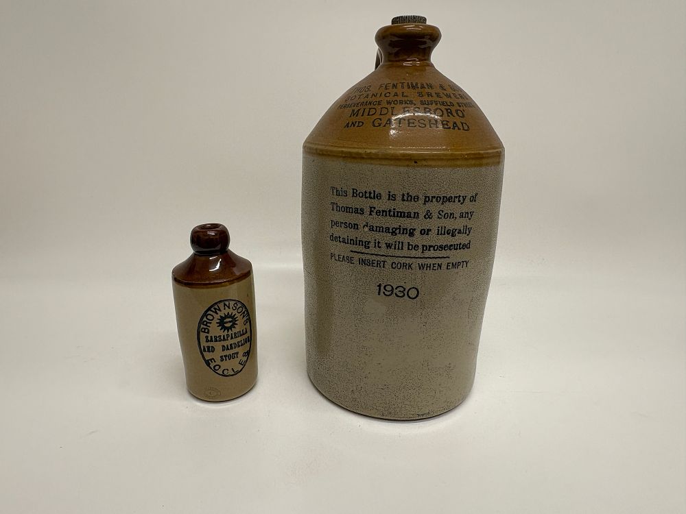 Lot 606: Two English Two-Tone Salt-Glazed Stoneware Botanical Beverage Bottles for Fentiman and Son and Brownson's