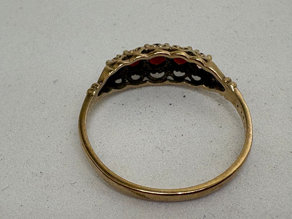 Lot 37: A 9 carat yellow gold five-stone garnet ring circa 1.34g gross