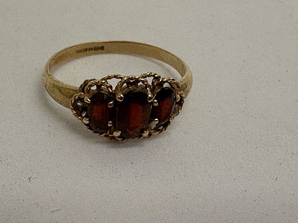 Lot 36: A 9 Carat Yellow Gold and Garnet Three-Stone Ring gross circa 1.73g gross
