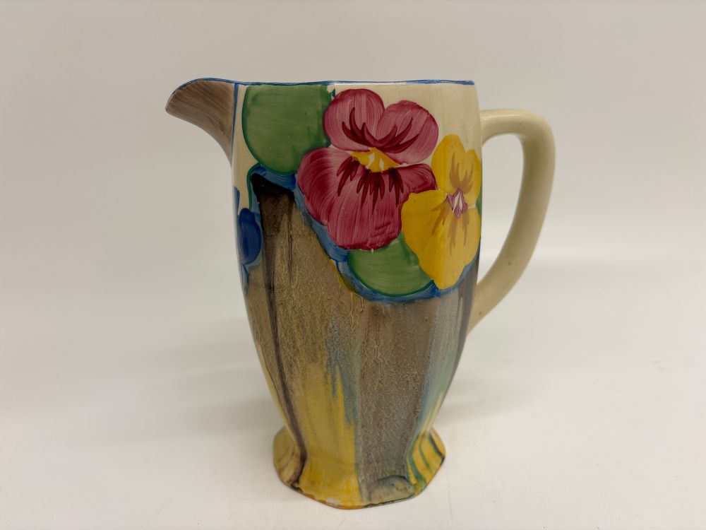 Lot 555: A Clarice Cliff Bizarre Pansies pattern Coronet earthenware jug