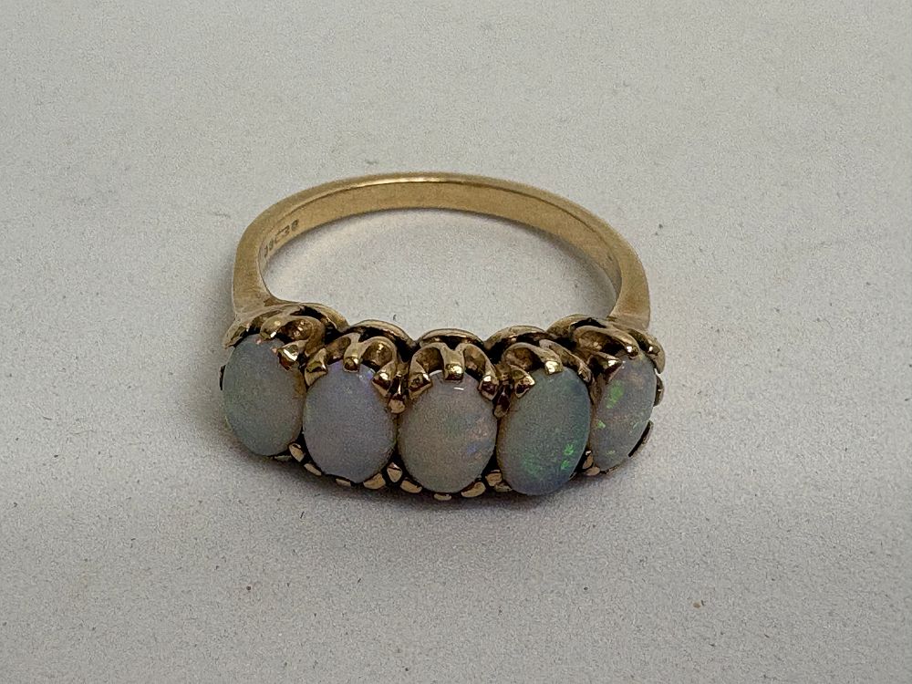 Lot 28: A 9ct gold five-stone opal bridge ring circa 3.3g gross