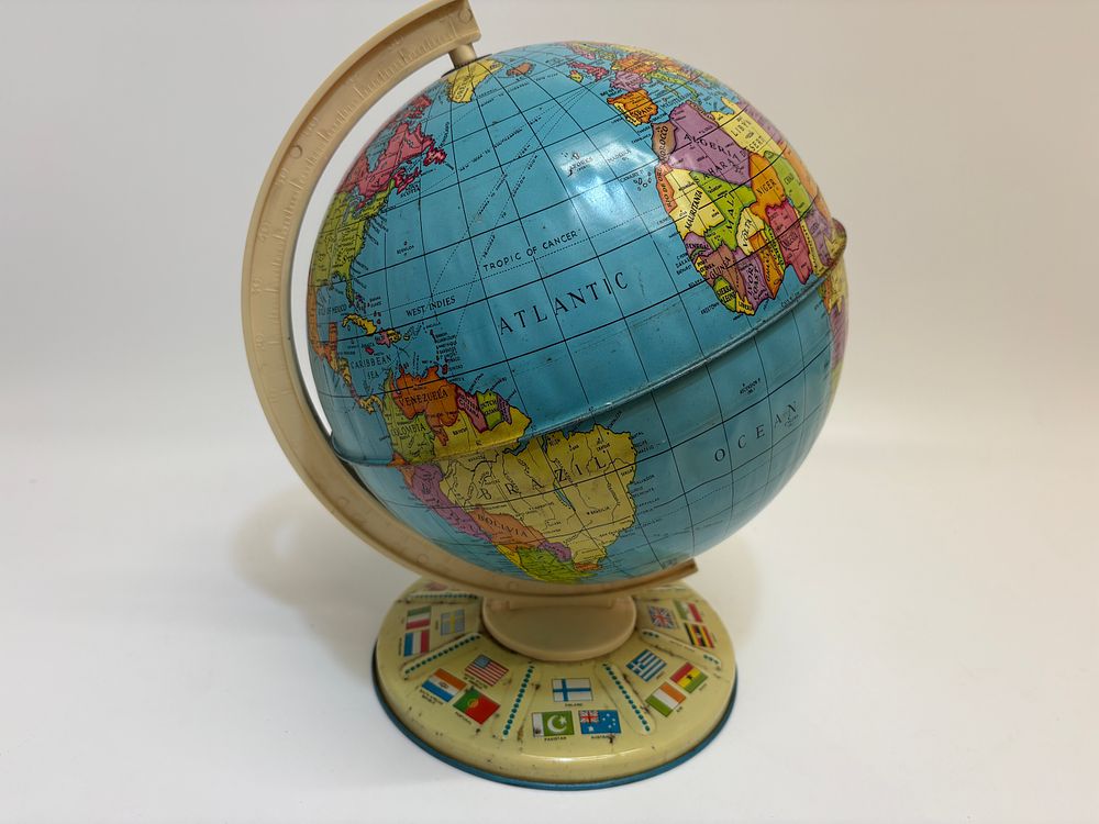 Lot 380: Vintage mid-1960s lithographed tinplate toy world globe with flag-motif base