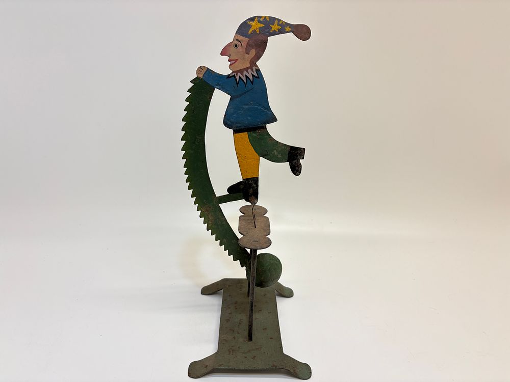 Lot 378: Vintage hand-painted jester and saw pendulum balance toy on stand 34cm tall