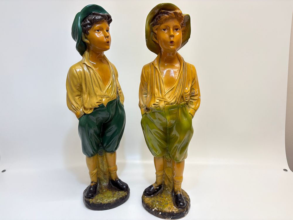 Lot 374: A pair of large painted composition whistling boy figurines 60cm tall
