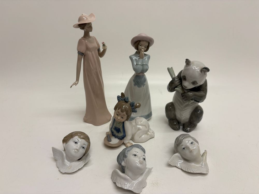 Lot 493: A collection of Spanish glazed porcelain figurines and wall plaques including Lladró, Nao, and Nadal