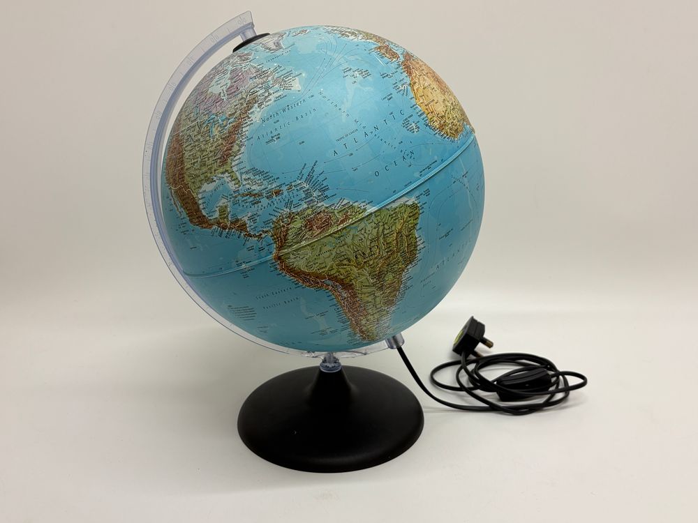 Lot 437: An illuminated dual-map table globe on a black circular base