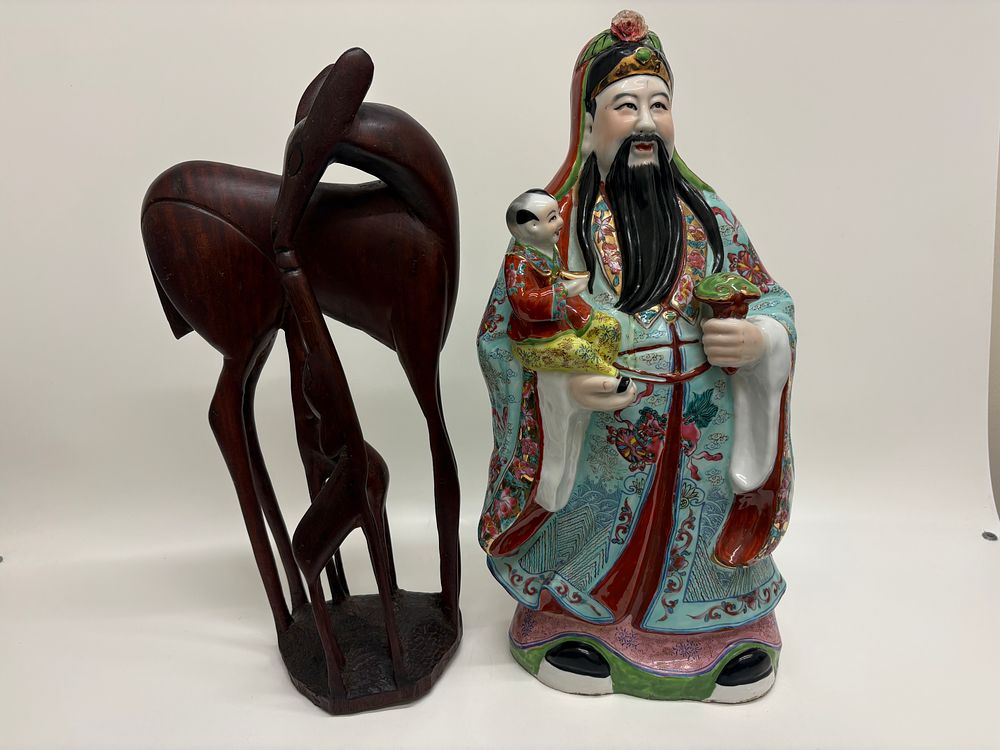 Lot 159: A Chinese polychrome porcelain figure of Lu Xing and a carved hardwood deer sculpture