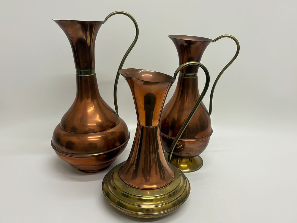 Lot 211: A Trio of Graduated Copper and Brass Decorative Ewers