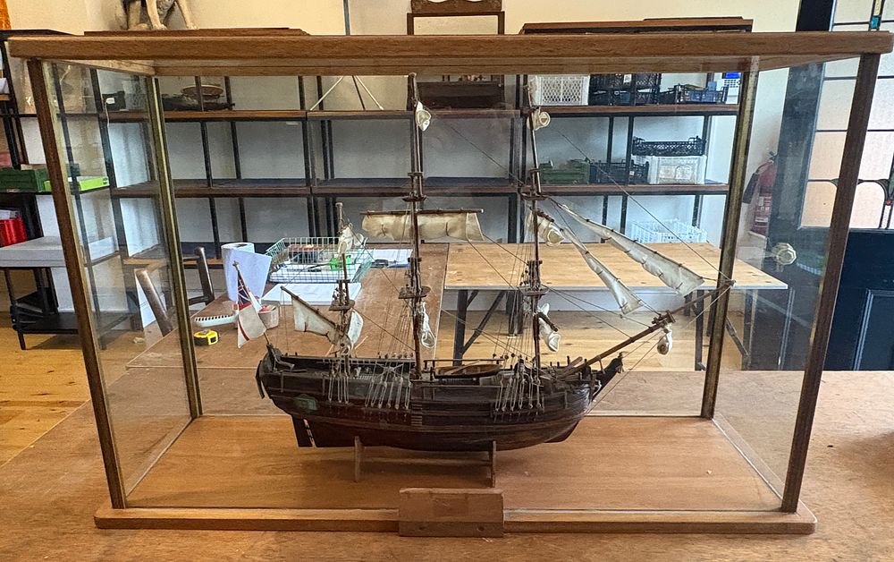 Lot 210: A wooden three-masted sailing ship model in glass display case