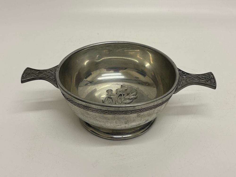 Lot 364: A Celtic Revival white metal quaich with thistle motif