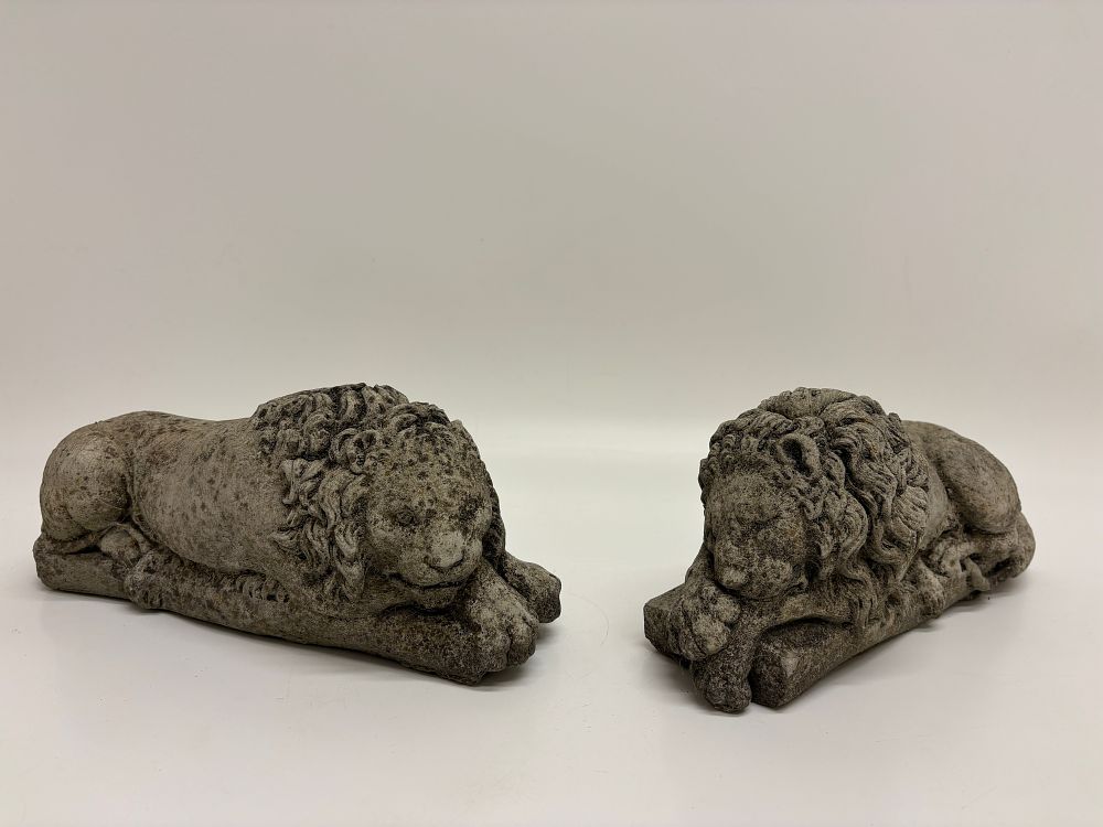 Lot 214: A Pair of Cast Stone Recumbent Lion Garden Statues