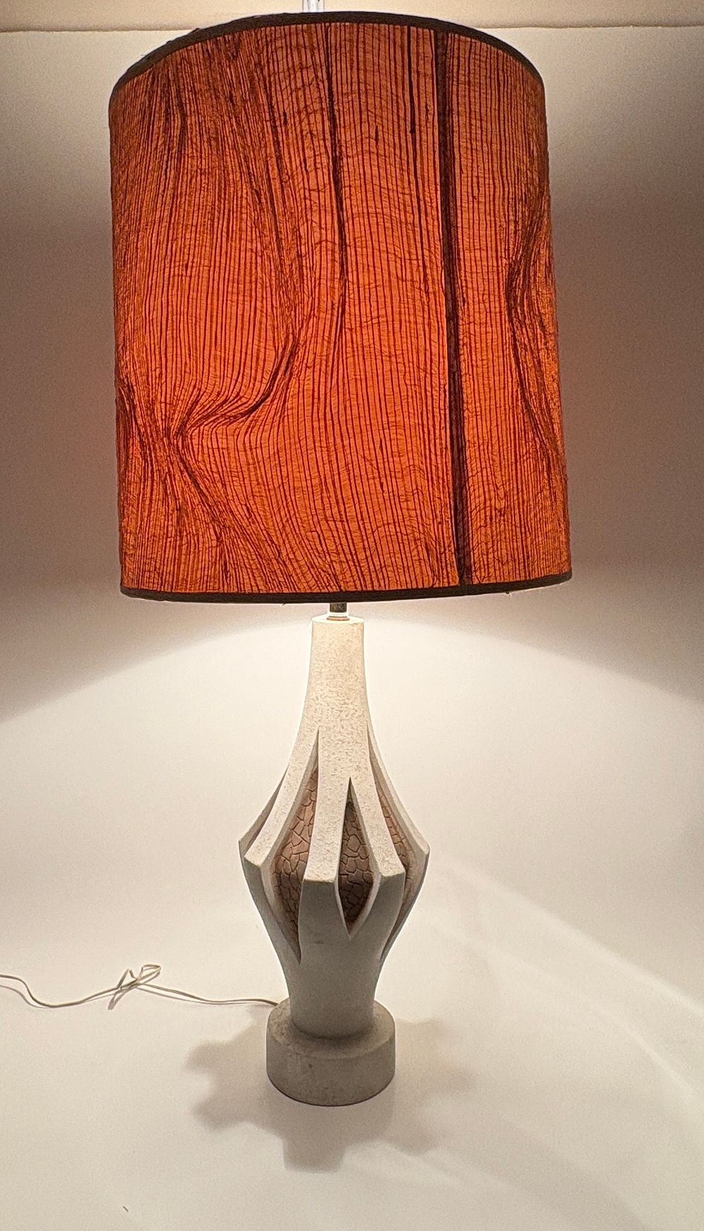 Lot 165: A Brutalist style sculptural ceramic table lamp with burnt orange cylindrical shade