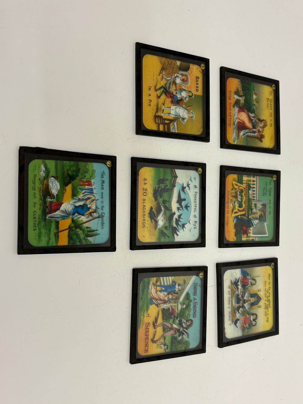 Lot 216: A Set of Seven Hand Coloured Glass Magic Lantern Slides Sing a Song of Sixpence