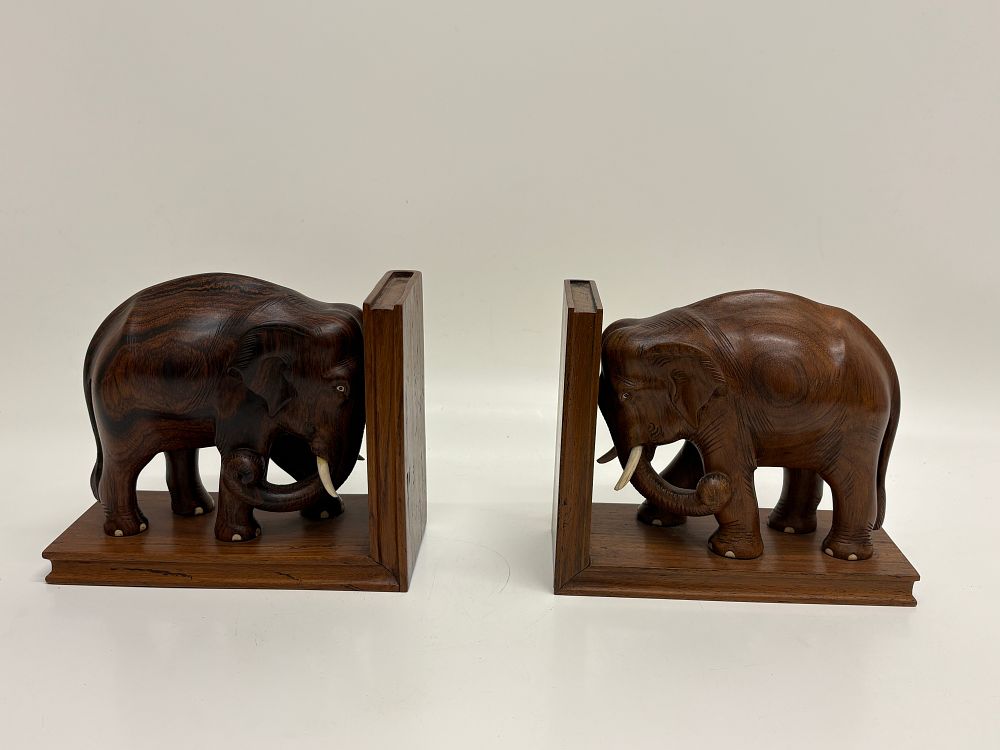 Lot 222: A pair of hand-carved rosewood elephant bookends, Kerala, India, dated 1965