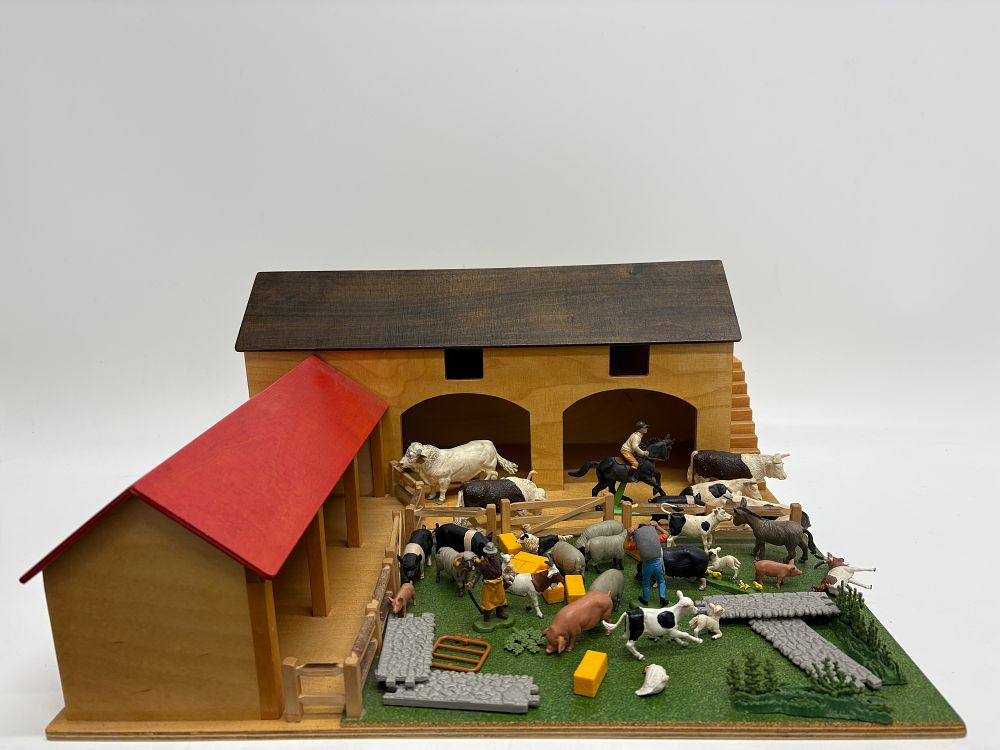 Lot 491: A Large Collection of Britains Plastic Farm Animals and Wooden Buildings