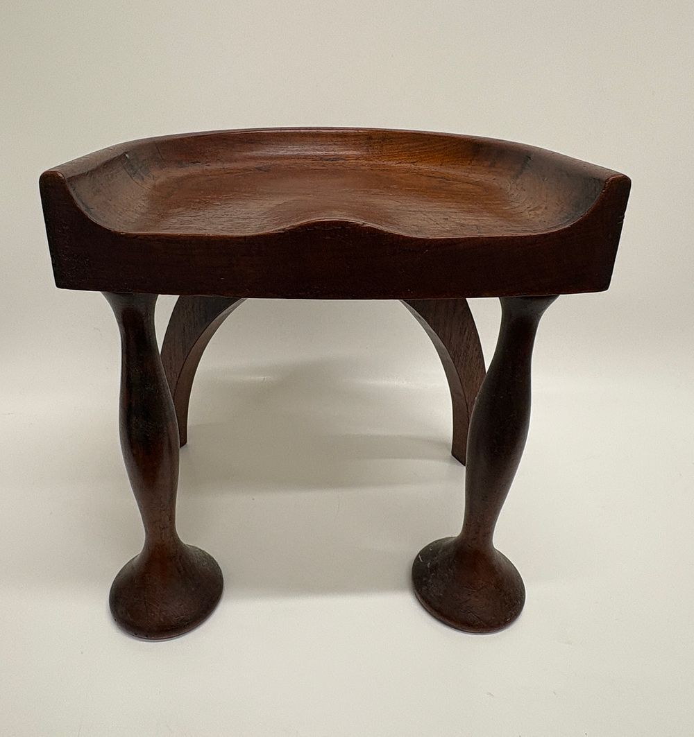 Lot 401: A Vernacular Carved Hardwood Milking Stool