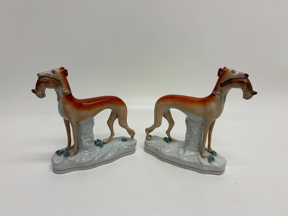 Lot 518: A Pair of Staffordshire Pottery Greyhound Hounds with Hares