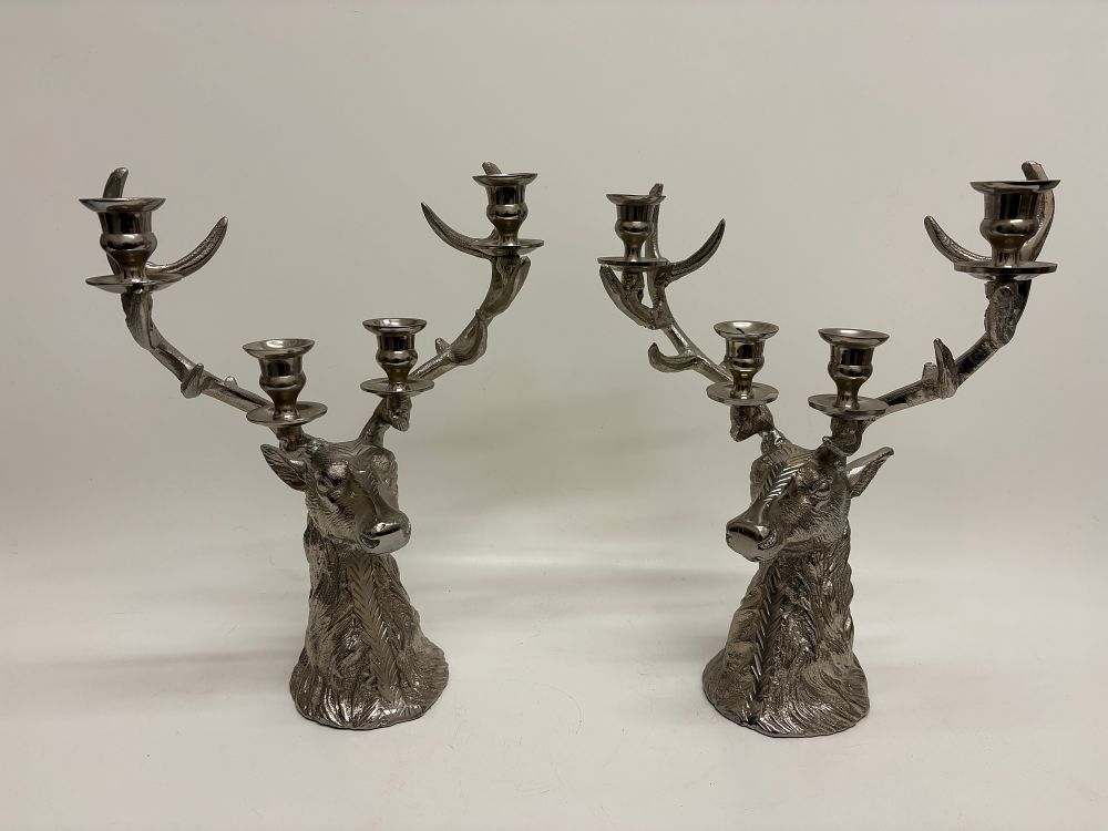 Lot 428: A Pair of Culinary Concepts London Contemporary Polished Metal Stag Head Four-Light Candelabra