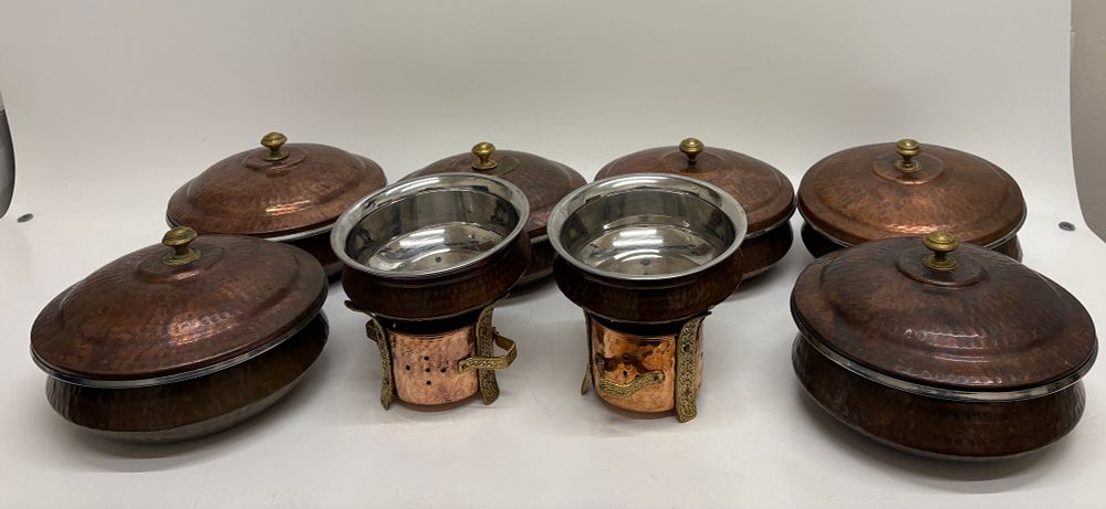 Lot 446: A set of eight hammered copper and stainless steel balti serving bowls and warming stands