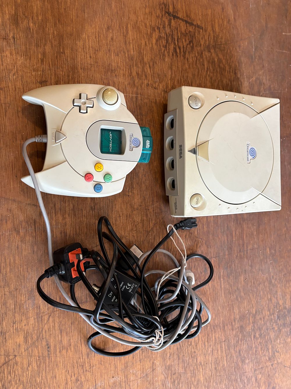 Lot 551: A Sega Dreamcast Home Video Game Console System with Controller and Accessories