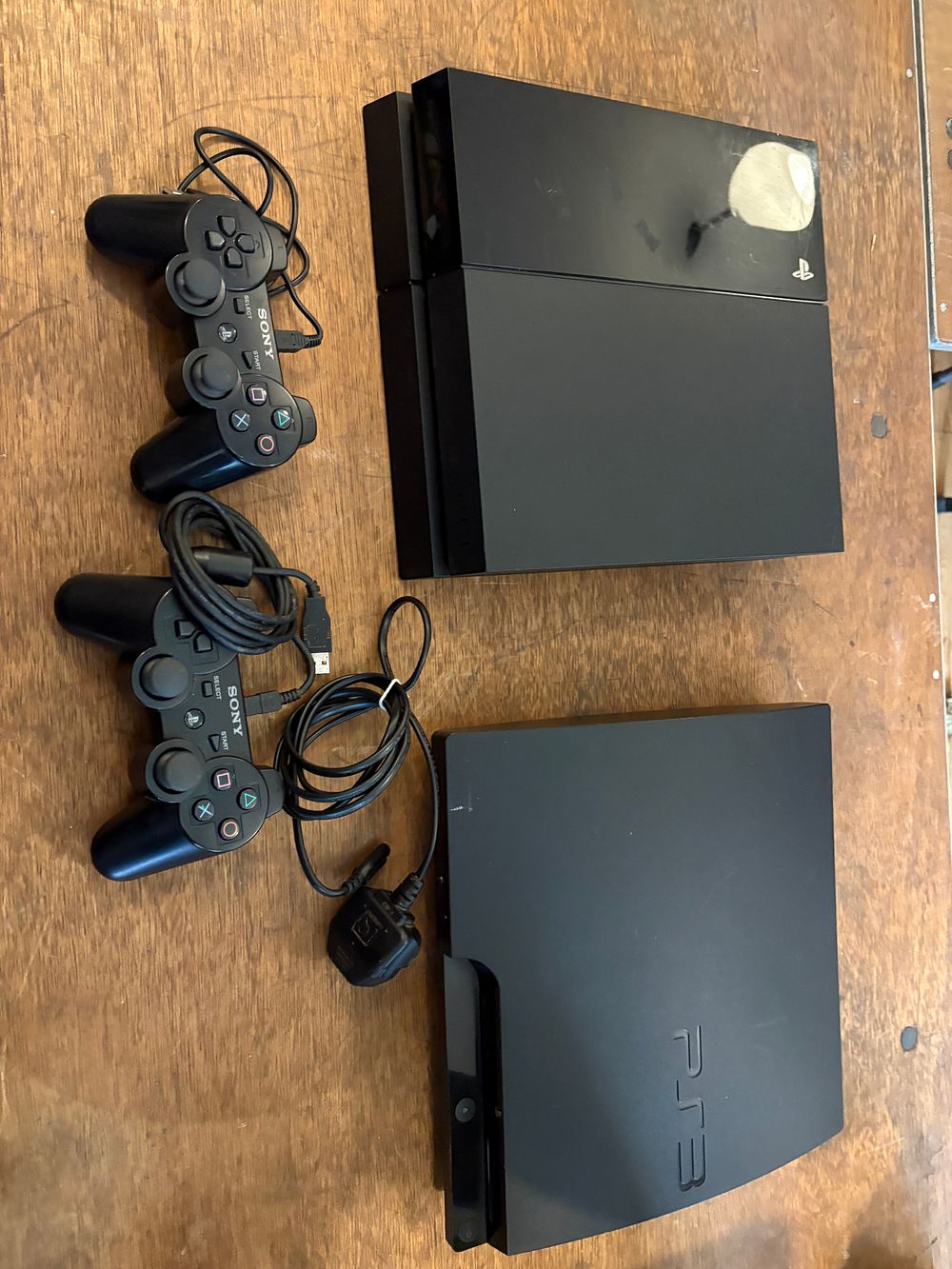 Lot 555: Two Sony PlayStation Video Game Consoles with Controllers and a Collection of PlayStation 3 Games
