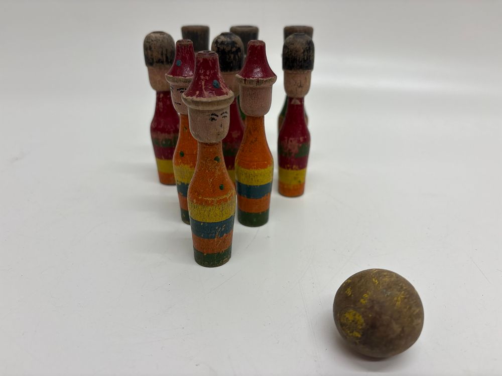 Lot 561: A Set of Nine Hand-Painted Wooden Skittles and Ball