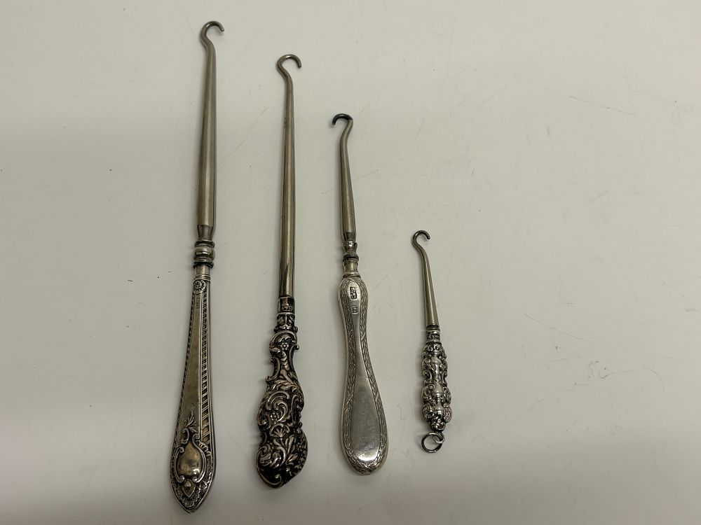 Lot 58: A Group of Four Late Victorian Sterling Silver Handled Button Hooks gross circa 68g