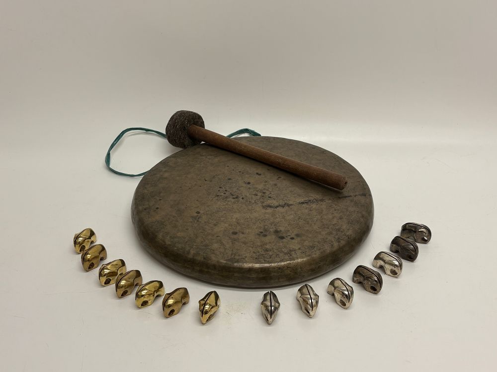 Lot 632: A Southeast Asian Bronze Gong With Mallet and a Collection of Metal Bells and Gilded Napkin Rings