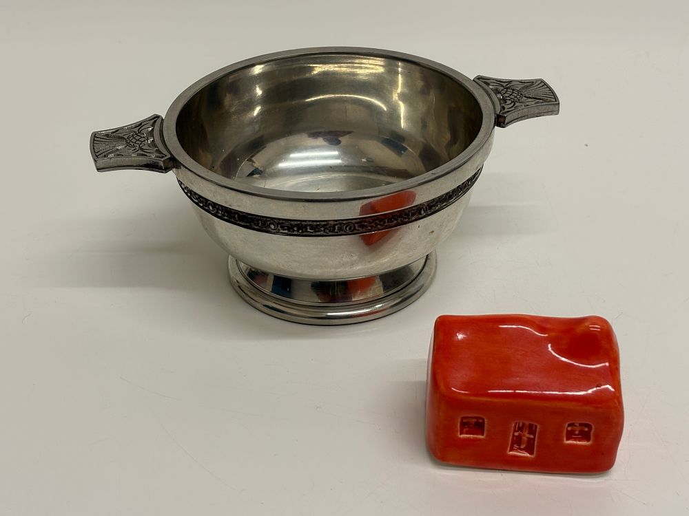 Lot 643: A Pewter Thistle Motif Quaich and a Miniature Ceramic Building