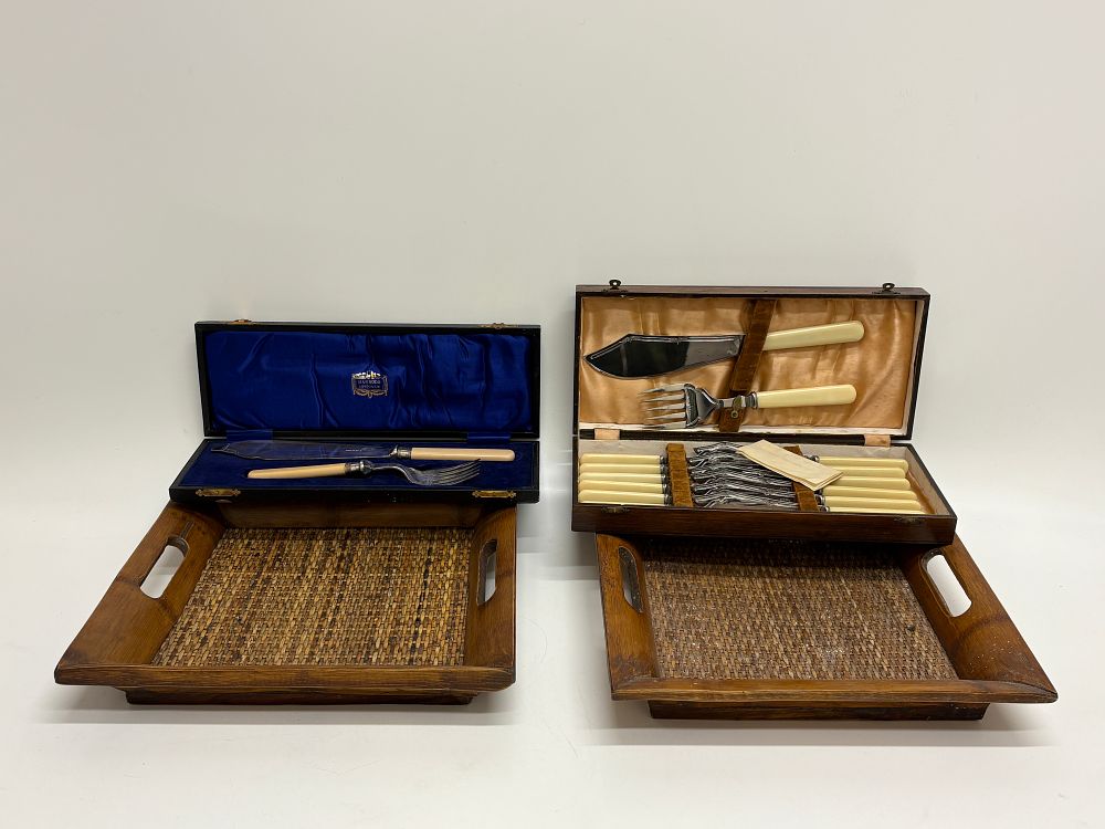 Lot 678: A Group of Cased Fish Serving Sets and a Pair of Woven Rattan Trays