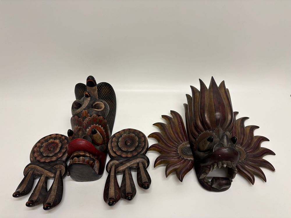 Lot 110: A Pair of Sri Lankan Polychrome Painted Wooden Naga and Gurulu Raksha Masks