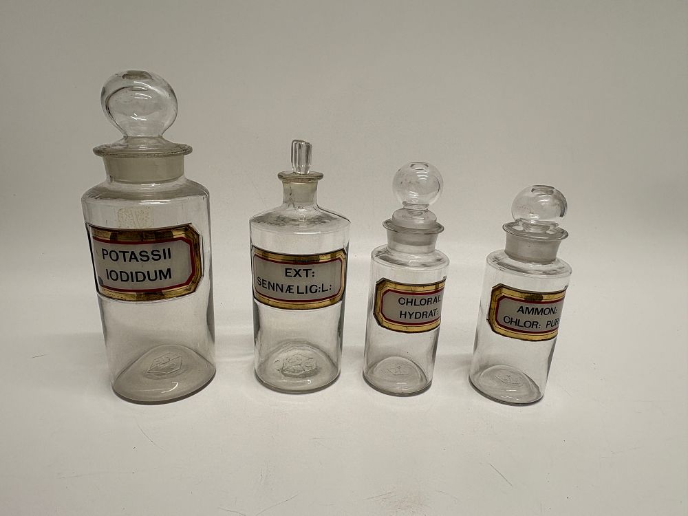 Lot 602: A Set of Four Antique Glass Apothecary Jars with Ground Glass Stoppers
