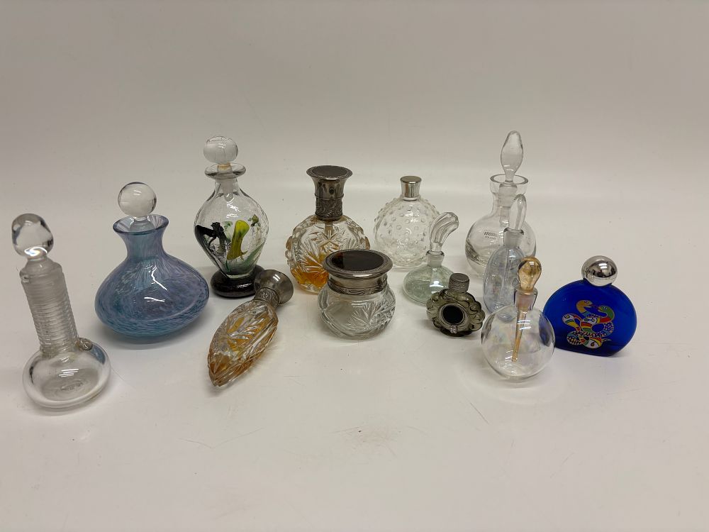 Lot 605: A Collection of Fourteen Decorative Glass and Silver Mounted Vanity Bottles and Jars