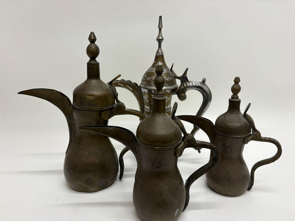 Lot 231: A Collection of Four Middle Eastern Dallah Coffee Pots