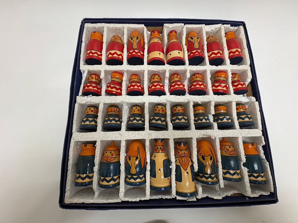 Lot 710: A 32-piece hand-painted wooden folk art chess set in original box