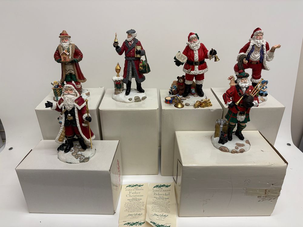 Lot 722: A Collection of Six The Hamilton Collection International Santa Figurine Collection Porcelain Figurines