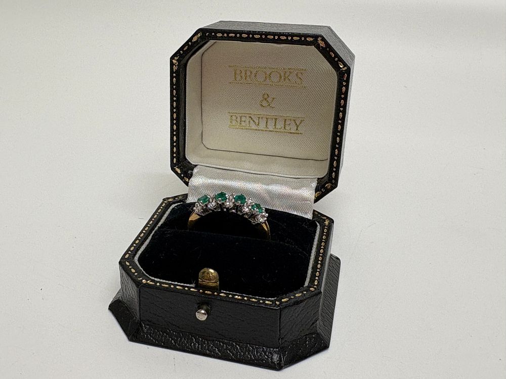 Lot 40: An 18 carat gold emerald and diamond half-eternity ring Sire R gross circa 4.92g
