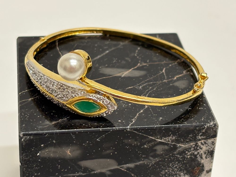 Lot 30: Gold Plated Bypass Bangle Bracelet with Pearl and Green Gemstone