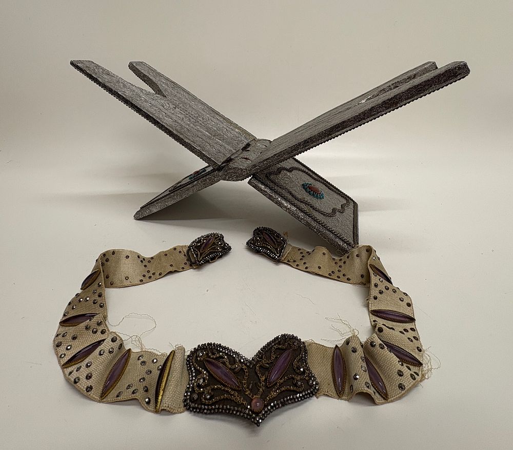 Lot 741: A Middle Eastern Repoussé Metal Clad Folding Book Stand and a Jewelled Textile Belt