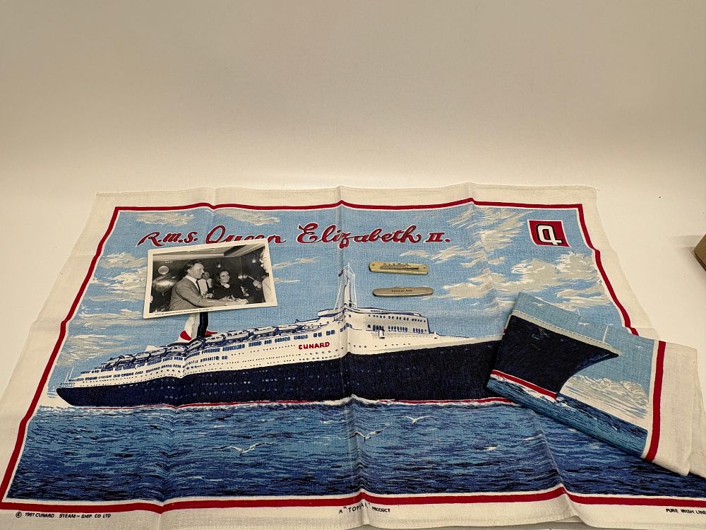 Lot 746: Richard Burton and Elizabeth Taylor Signed Photograph onboard RMS Queeen Mary + other Cunard Line Memorabilia and
