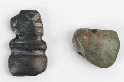 Pre-Columbian Jade Pendants. One is a celt pendant and the other is carved animal head / axe
