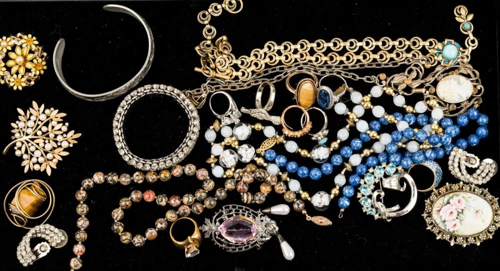 Vintage Jewelry Collection. Sampling includes "Hobe" tiger eye style pin, "Trifari" pin (missing 