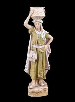 Royal Dux Porcelain Figurine #1058. A Royal Dux porcelain figurine of a boy with basket atop the 