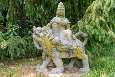 Antique Garden Sculpture Kwan Yin Riding a Lion. Monumental antique carved granite garden 