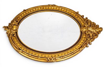 Gilt Wood & Gesso Oversized Beveled Mirror. An oversized oval beveled mirror framed in an 