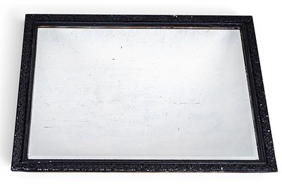 Large Ornate Black Framed Beveled Mirror. A large beveled mirror in an ornately carved wood 